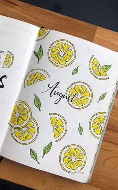 an open notebook with lemons and leaves on it