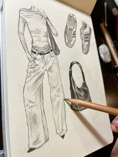 a drawing of a woman's clothes and shoes with pencils next to it