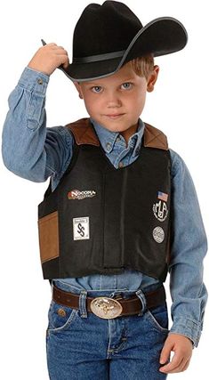 a young boy wearing a black cowboy hat and leather vest with patches on the chest