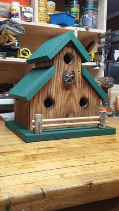 a bird house made out of wood and green roof