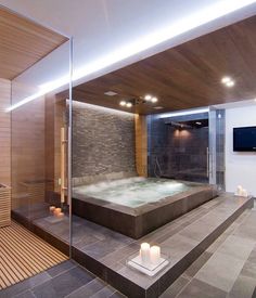 a bathroom with a large jacuzzi tub next to a flat screen tv