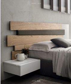 a bedroom with a bed, nightstands and pictures on the wall above it that have been made to look like wood