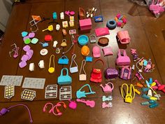 a table topped with lots of toys on top of a hard wood floor covered in clutter