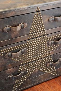 an old dresser with metal studded drawers