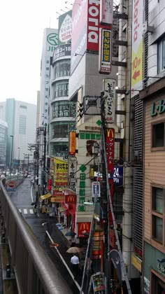 a city street with lots of signs on the buildings