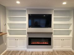 a living room with built in bookshelves and a fireplace