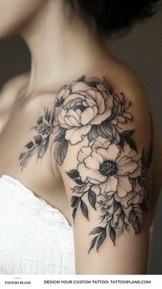 a woman's shoulder with flowers on it