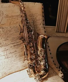 a saxophone sitting on top of an old piece of paper