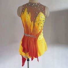 an orange and yellow dress on a mannequin