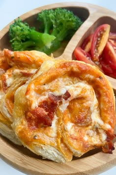 some food is on a wooden plate with broccoli and tomatoes in the background