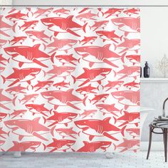 a red and white shower curtain with sharks on it