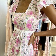 This Charming Sundress Features A Ruffled, Tiered Design In A Delightful Pink And White Color Scheme. The Square Neckline And Flutter Cap Sleeves Add A Playful Touch, Making It Perfect For Casual Or Resort Wear. Its Midi Length And Airy Style Ensure Comfort And Elegance For Any Sunny Day Outing. Has A Small Tear On The Lace That Holds The Ribbon But It’s Definitely Fixable And Still Wearable! Esfj Characters, Loveshack Fancy, Plum Colour, Pink Wardrobe, Princess Ballerina, Spring Fashion Chic, Lds Mission, Organizing Clothes, Printed Long Dress