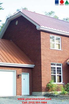 a red brick house with a metal roof