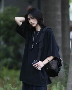 a woman standing in the street with her hand on her head