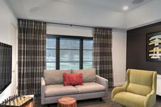 a living room filled with furniture and a flat screen tv