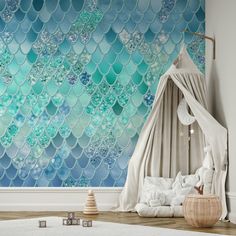 a room with a bed, rug and wallpaper that has mermaid scales on it