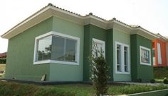 a green house with white trim and windows