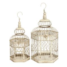 two white bird cages sitting next to each other