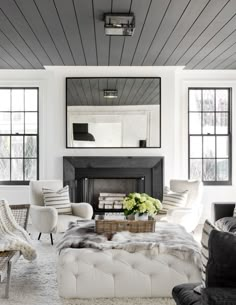 a living room filled with furniture and a flat screen tv on top of a wall