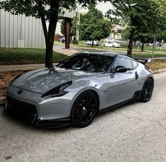 a silver sports car is parked on the street