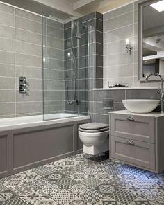 a bathroom with a toilet, sink and bathtub next to a shower stall in the corner