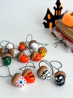 halloween decorations made out of corks on a table with pumpkins and other items