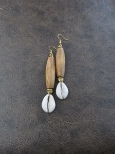 Cowrie shell and long brown wooden dangle earrings with French hooks Cowrie Shell Jewelry Necklaces, Diy Wooden Jewelry, Cowrie Jewelry, Bohemian Brown Cowrie Shell Jewelry, Shells Earrings, White Shell-shaped Cowrie Shell Earrings, Casual Cowrie Shell-shaped Jewelry, Earrings Space, Bohemian Jewelry With Shell-shaped Cowrie Shell