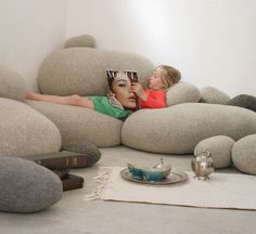 a woman laying on top of a couch covered in rocks