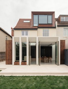 a modern house with an open patio and sliding glass doors on the front door area