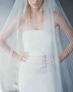 a woman in a white dress and veil