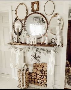 a mantel with logs and mirrors on it