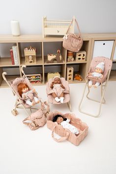 three dolls are sitting in their baby carriages