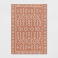 an orange and white rug with geometric designs