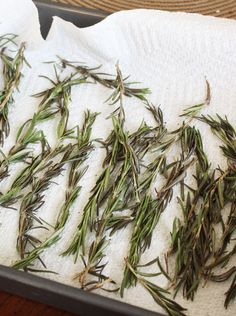 some green plants are laying on a white towel in a pan and ready to be cooked