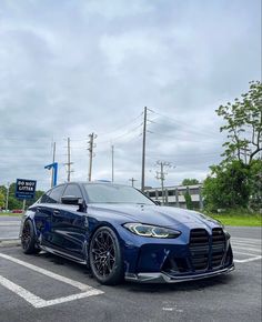 a blue sports car parked in a parking lot