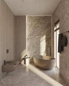 an elegant bathroom with stone walls and flooring