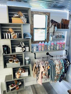 an organized closet with clothes and shoes hanging on the rack, in front of a window