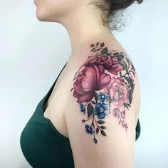 a woman with a flower tattoo on her shoulder