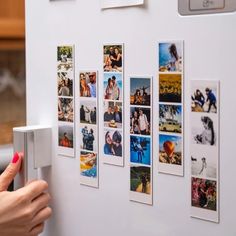 a refrigerator door is covered with pictures and magnets on the front, while a woman's hand reaches for it