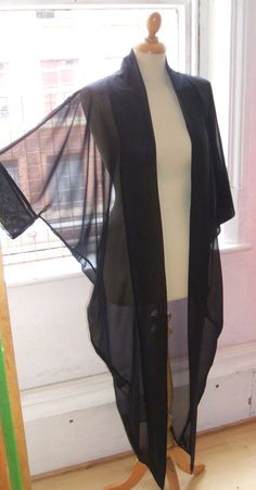 Black Open Front Kimono For Festival, Fitted Black Kimono For Beach, Black Long Party Robe, Black One Size Open Front Kimono, Black Open Front Evening Kimono, Elegant Black Festival Cover-up, Black Long Party Cover-up, Black Kimono With Kimono Sleeves For Party, Black Long Sleeve Kimono For Party