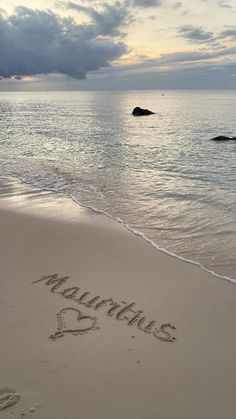 the word love written in the sand at the beach