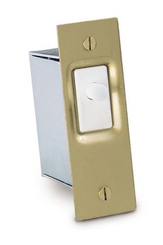 the light switch is gold and has a white button on it's side,