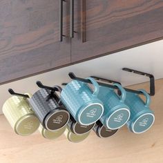 The under cabinet coffee mug holder is constructed with thick and durable iron that won't bend easily and has super load-bearing(15KG/30LBThe dip-plastic and spray-paint finish make the mug rack non-slip and rustproofThe minimalist design of the mug hooks under cabinet with straight rods instead of hooks allows the mug organizer to hang more types of mug handles without worrying about unused hooks due to the small hook spacingThis mug hanger under cabinet or shelf can easily hang your mugs and Mug Hanger, Coffee Mug Storage, Coffee Cup Storage, Tiny Pantry, Under Cabinet Organization, Hanging Mugs, Coffee Bar Accessories, Coffee Mug Display, Mug Storage