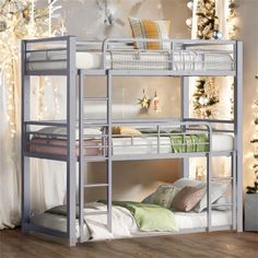 the bunk bed has two sets of ladders on each side, and is decorated with christmas lights