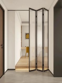 an open room divider in the middle of a hallway with wood floors and white walls