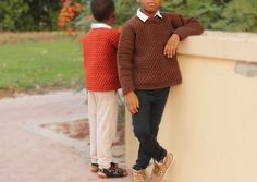 two young boys standing next to each other