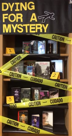 a book shelf with caution tape around it and books on the shelves in front of it