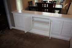 a white counter top sitting under a window in a living room