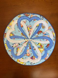 a blue and white plate sitting on top of a wooden table