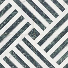 a marble tile with white and green designs on it's sides, in the shape of diagonals